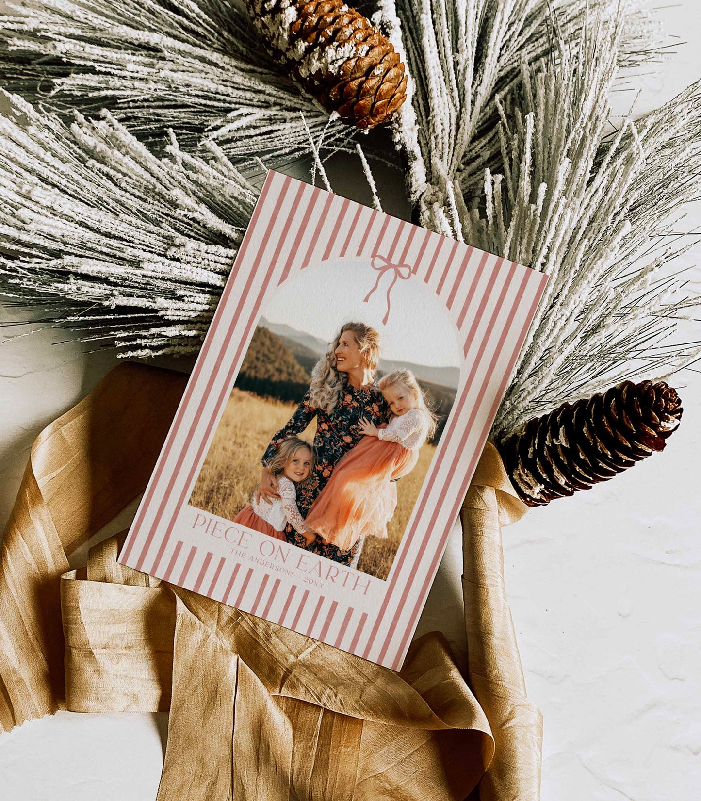 Stripped card with photo of a family and pinecones and dried grasses on a light background