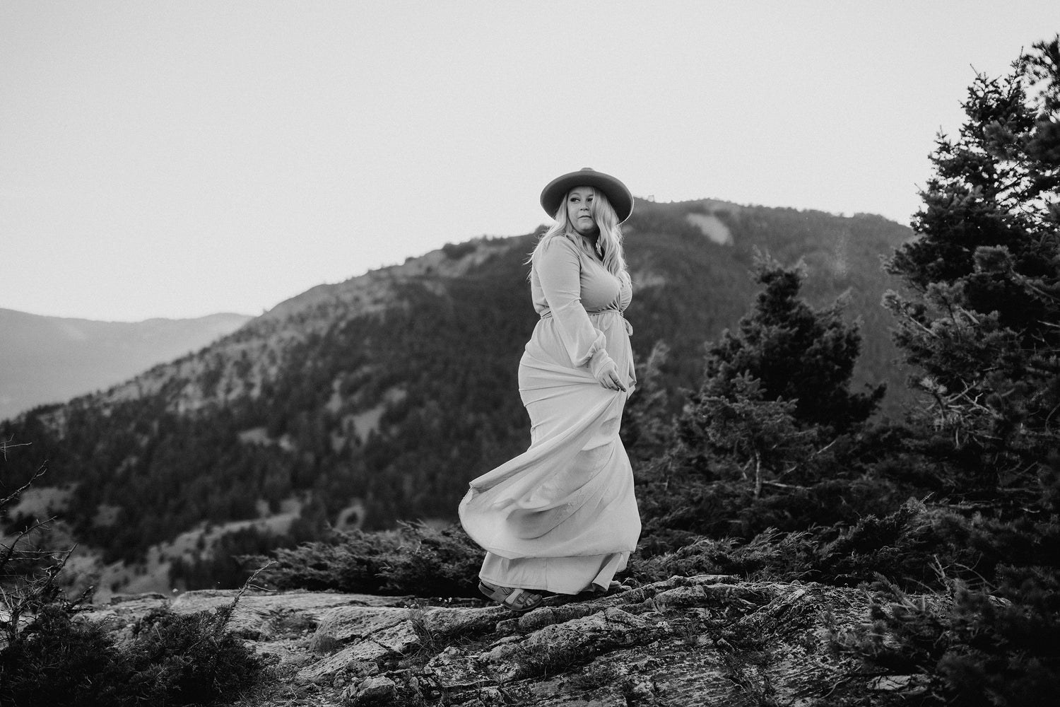 Photo of shannon savage owner of High Peaks Studios dancing on a mountain top - High Peaks Studios