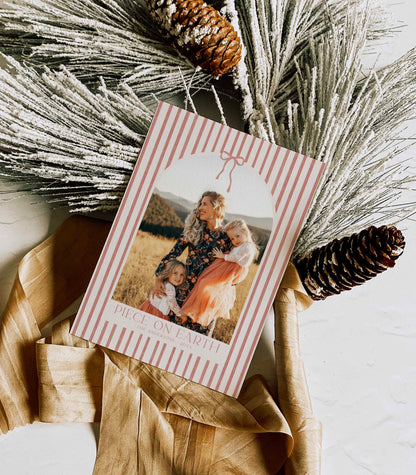 Stripped card with photo of a family and pinecones and dried grasses on a light background