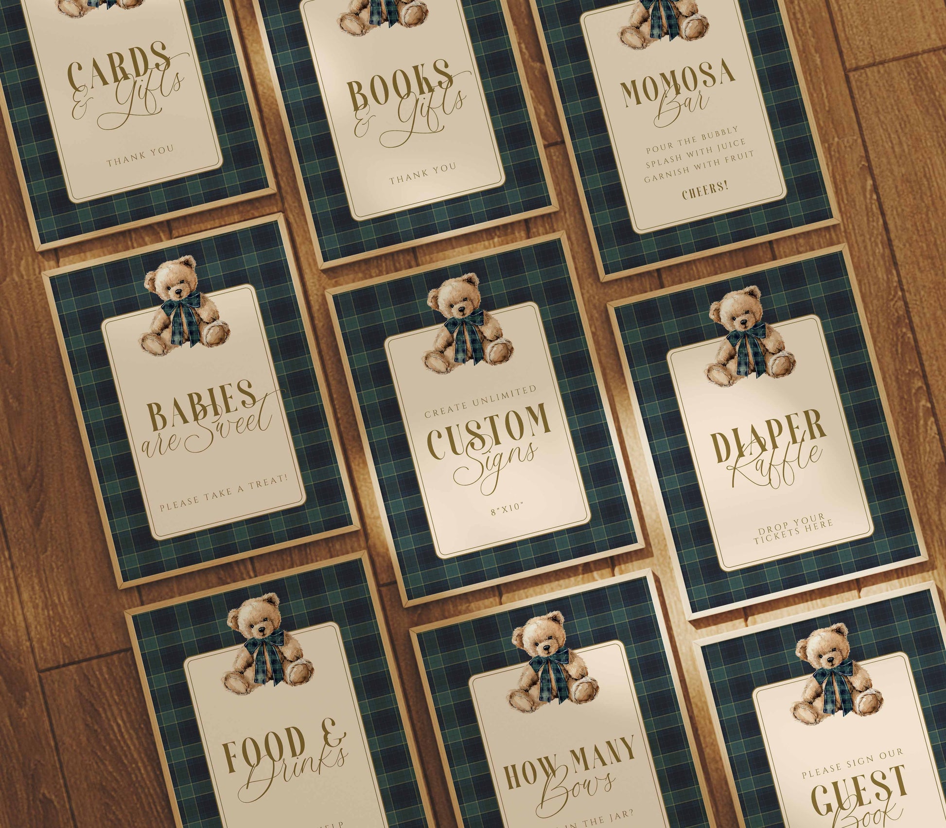 Collection of baby shower party signs with teddy bears and text on a wooden surface