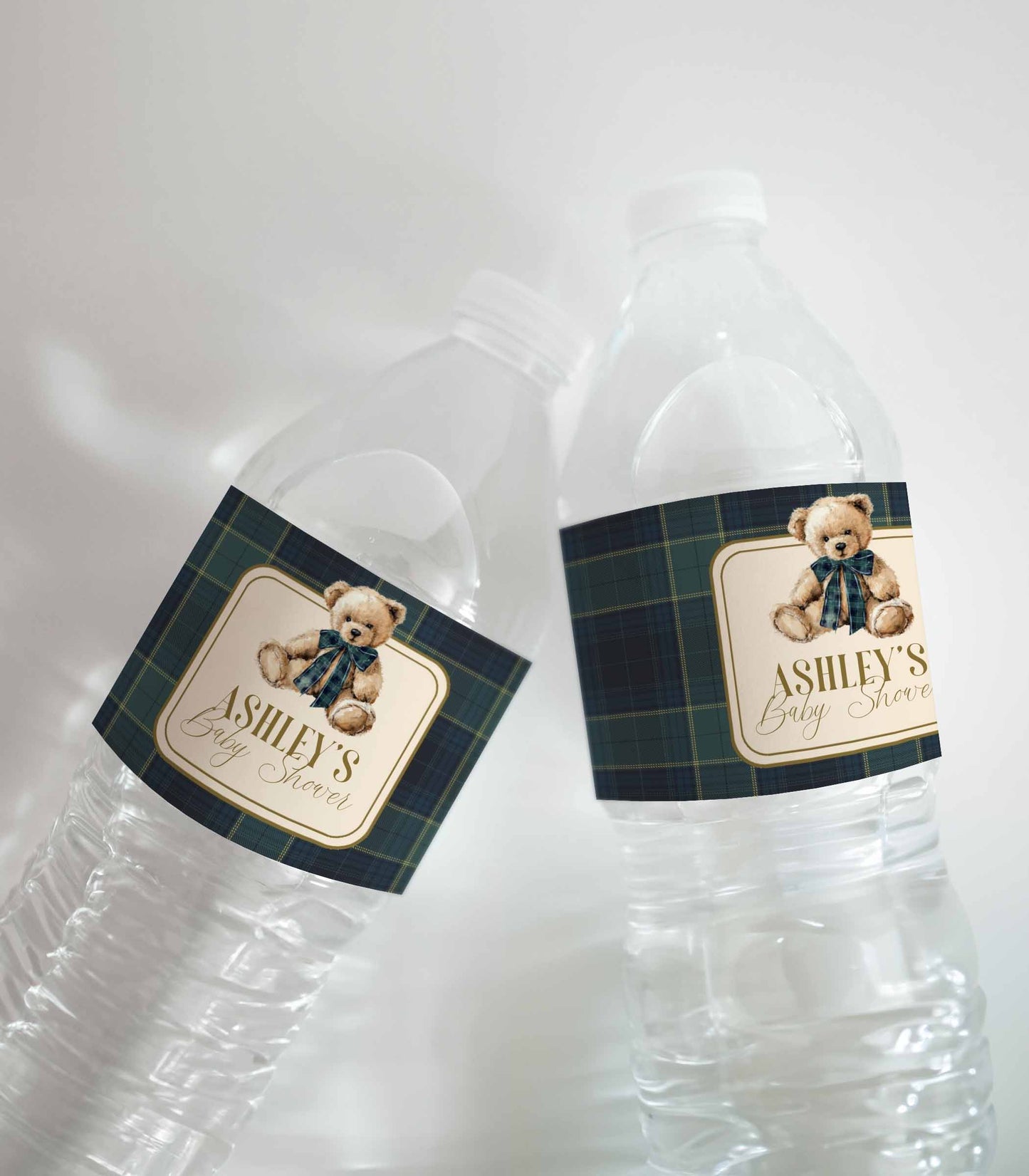Two clear water bottles with personalized labels featuring teddy bears and text on a plaid background.