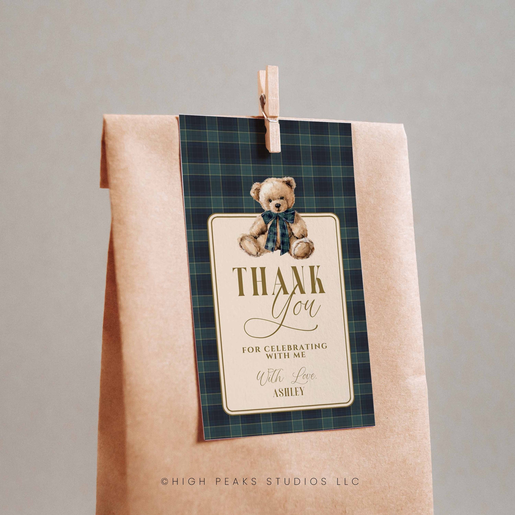 Kraft paper bag with a plaid label featuring a teddy bear and 'Thank You' message on a gray background.