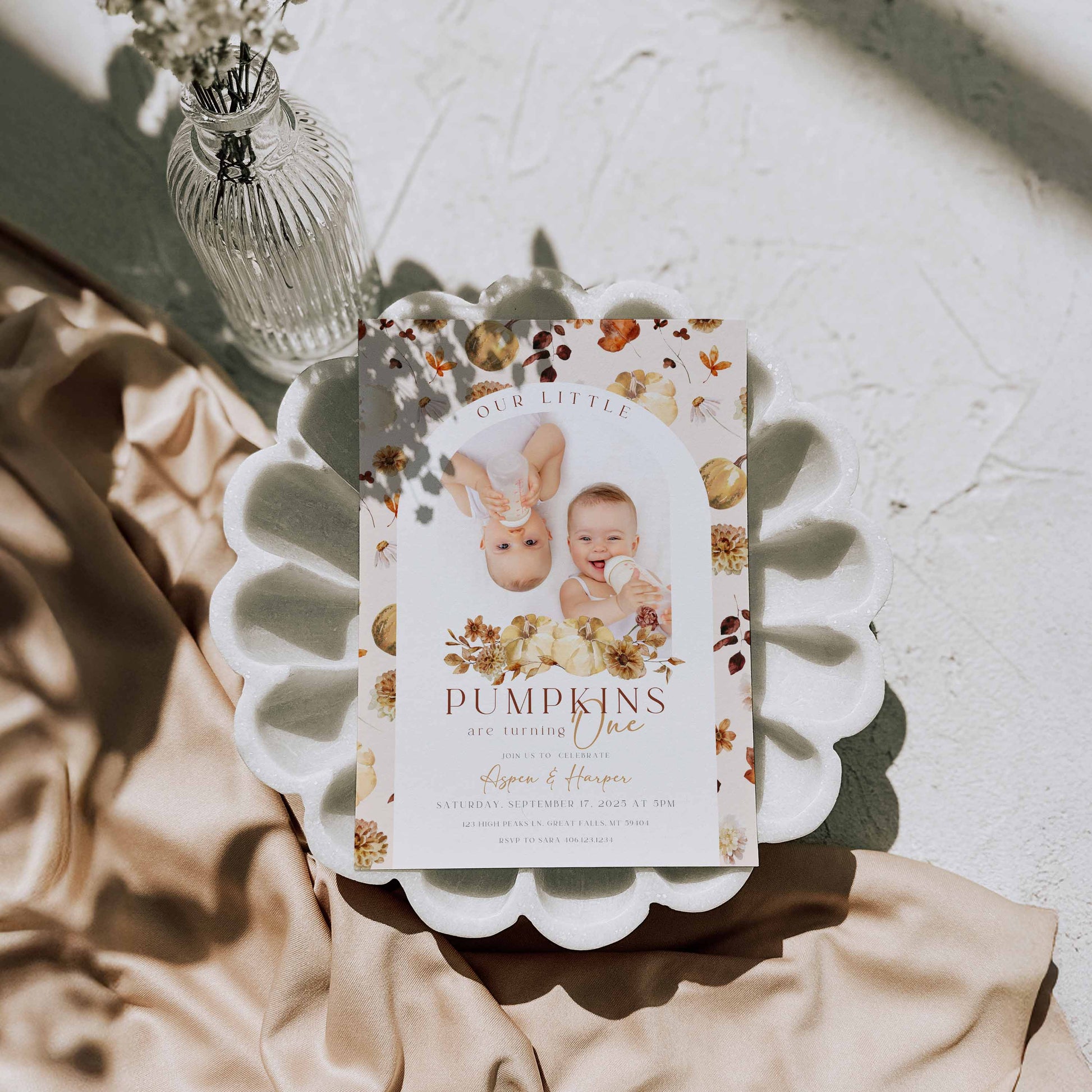 Editable Our Little Pumpkins Twin Birthday Invitation Photo By High Peaks Studios with floral design and baby photo on a decorative plate.