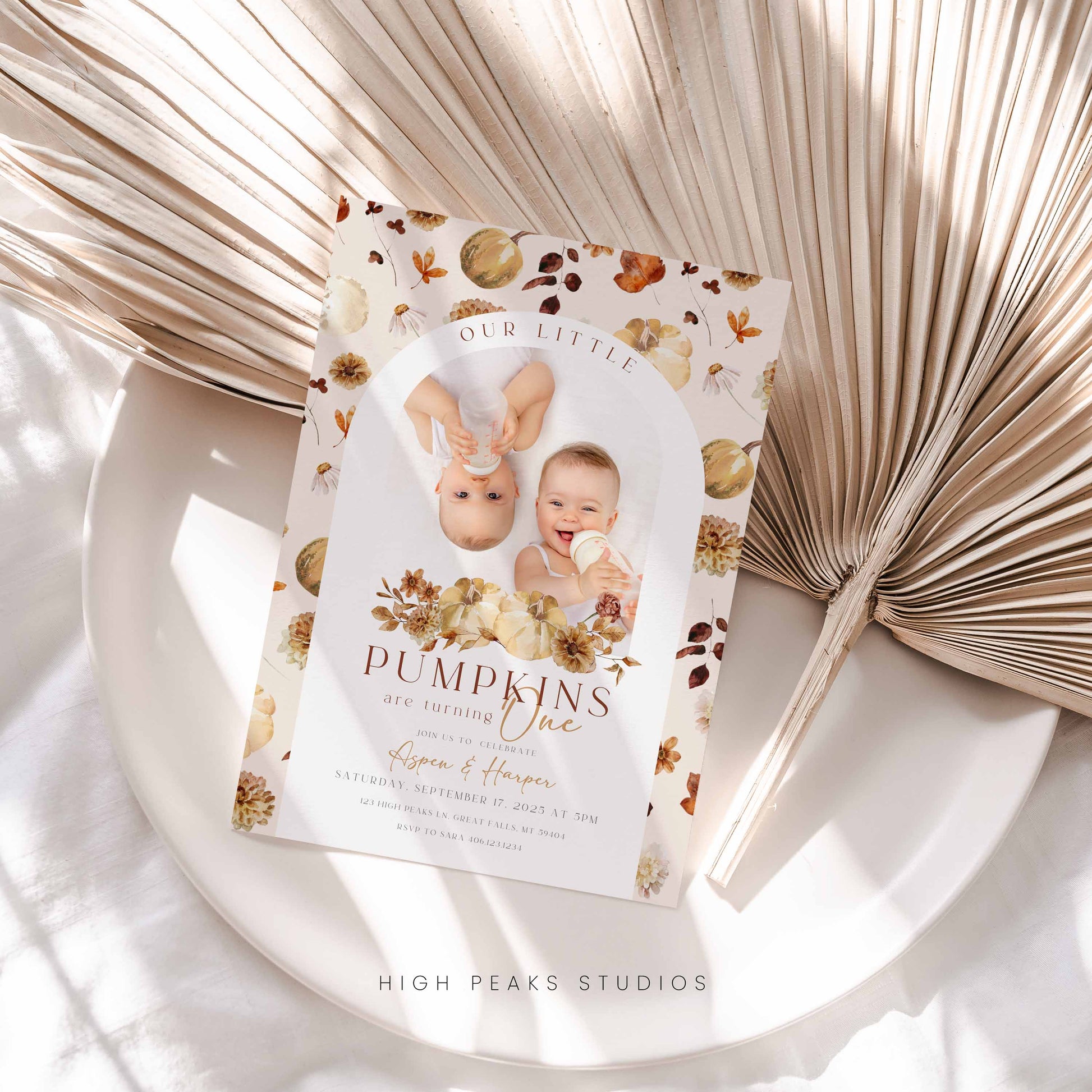 Invitation card with baby photos and floral design on a decorative surface Editable Our Little Pumpkins Twin Birthday Invitation Photo By High Peaks Studios