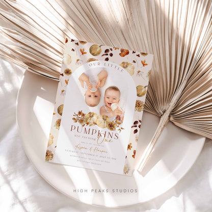 Invitation card with baby photos and floral design on a decorative surface Editable Our Little Pumpkins Twin Birthday Invitation Photo By High Peaks Studios