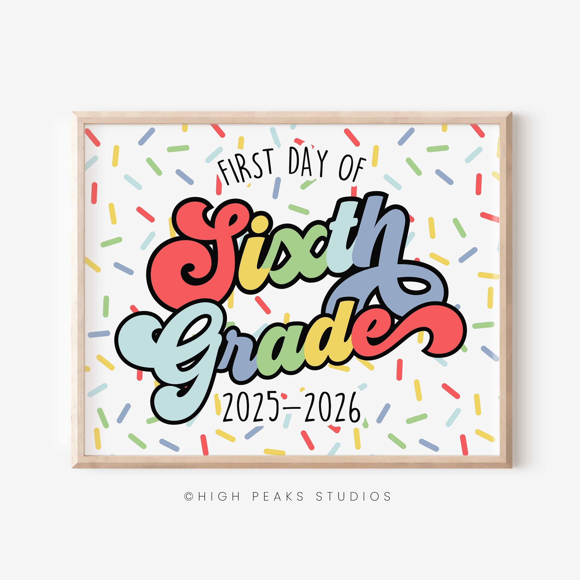 Framed sign with 'First Day of Sixth Grade 2025-2026' text on a white background with colorful confetti pattern.