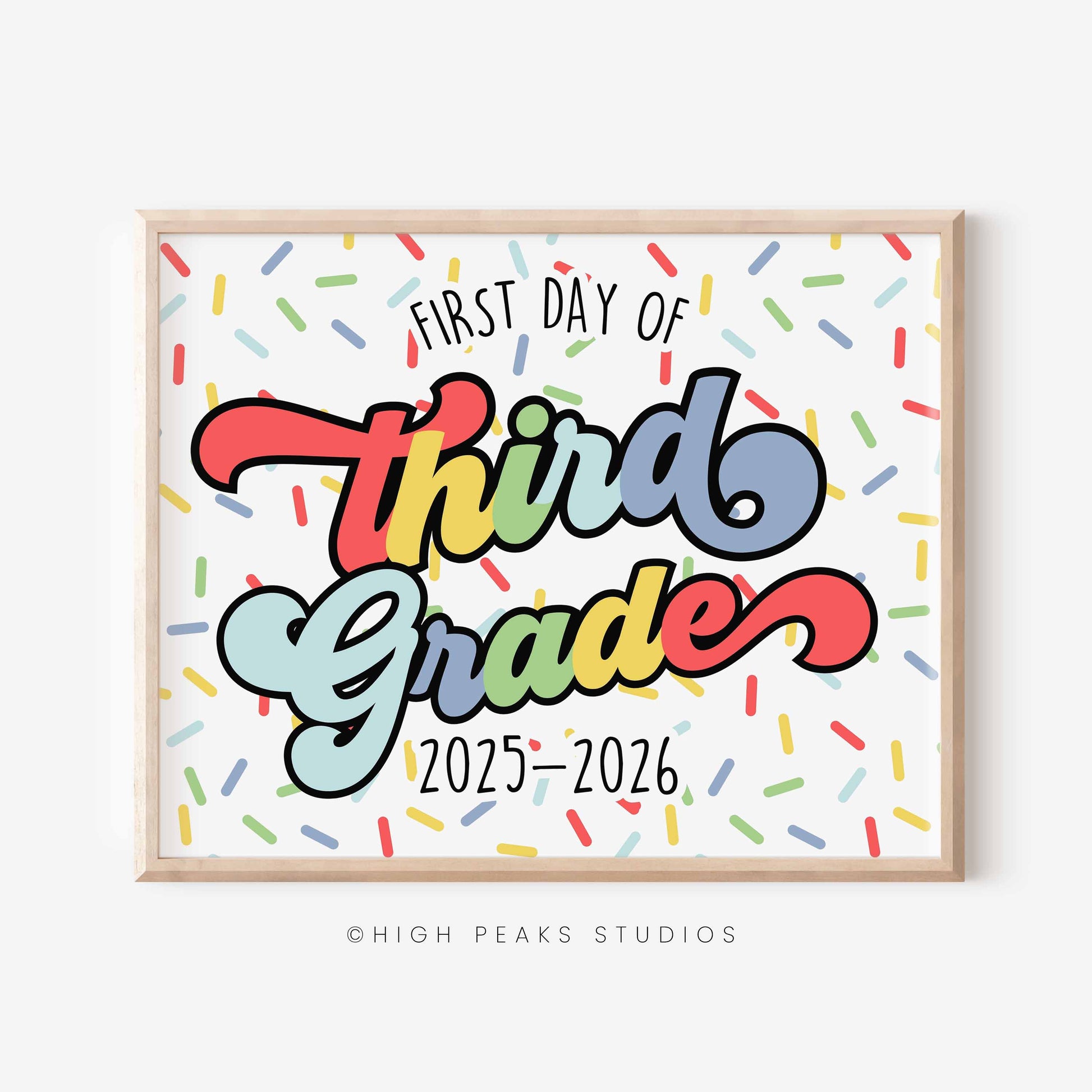 Framed poster with 'First Day of Third Grade 2025-2026' text on a colorful background, featuring the brand 'High Peaks Studios'.