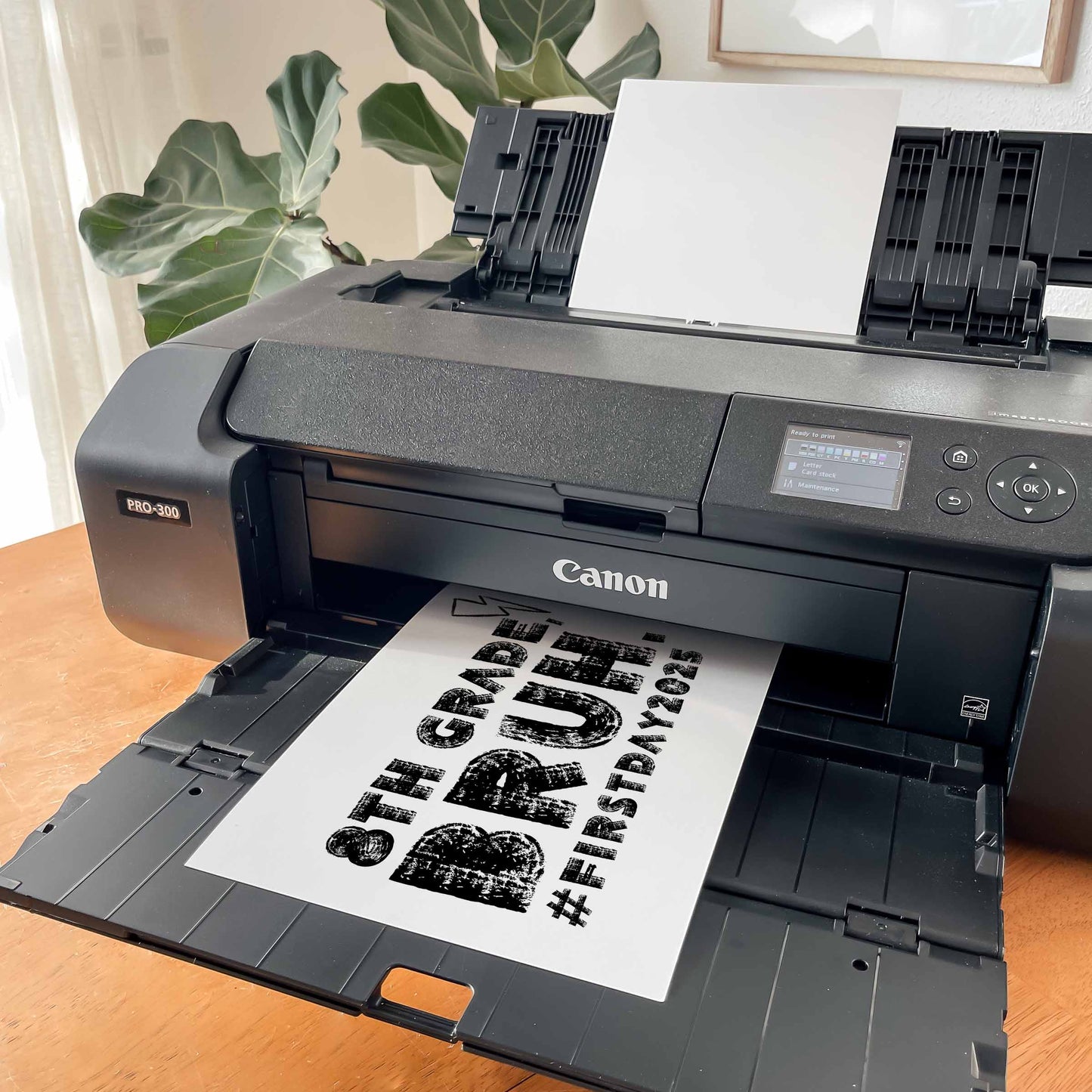 Canon printer printing a sheet of paper with text on a wooden table. First Day of 8th Grade, Bruh Sign Printable Photo Prop by High Peaks Studios LLC